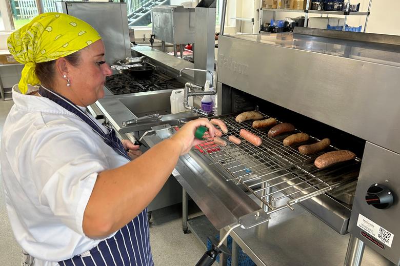 A home economist prepares sausage products for tasting as part of the UKSW judging process.