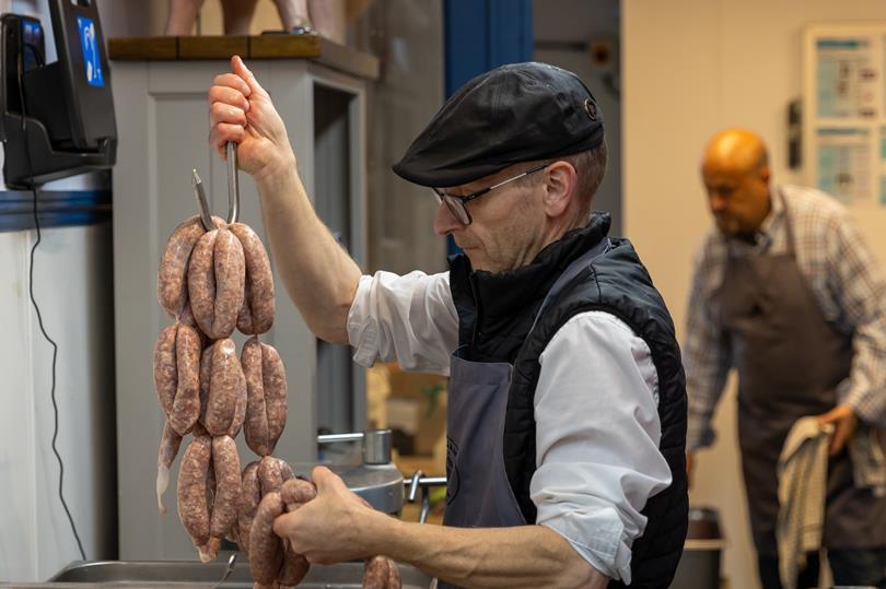 A home economist prepares sausage products for tasting as part of the UKSW judging process.