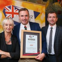 Best Independent Butcher South East Traditional Sausage: L-R: Host Lesley Waters with winner James Lally of James of Shepperton with category partner Anthony Daniels of Handtmann