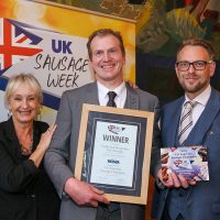 UK Supreme Sausage Champion: L-R: Host Lesley Waters with winner Darren Morgan of Morgan's Country Butchers with category partner Richard Watson of Reiser